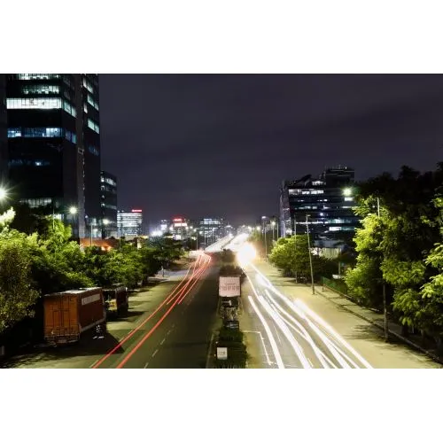 Night Road Poster The Night Road Poster features a captivating image of a nighttime road illuminated by street lights. The poster