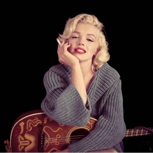 Marilyn Monroe Smoking With Guitar Marilyn Monroe Smoking With Guitar features the iconic actress looking effortlessly chic while