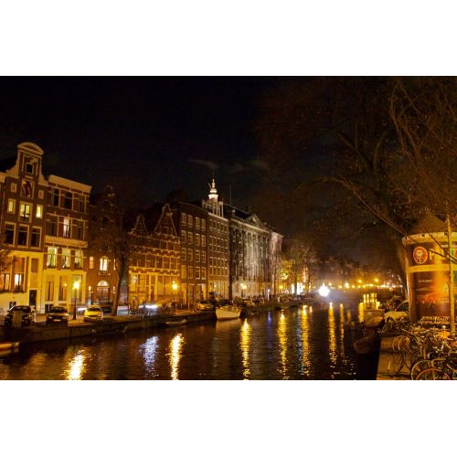Kloveniersburgwal Amsterdam At Night Poster The Kloveniersburgwal Amsterdam At Night Poster showcases the picturesque canal of